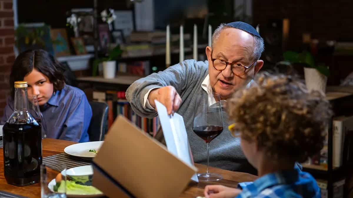 A grandfather and grandchild at the Passover table.