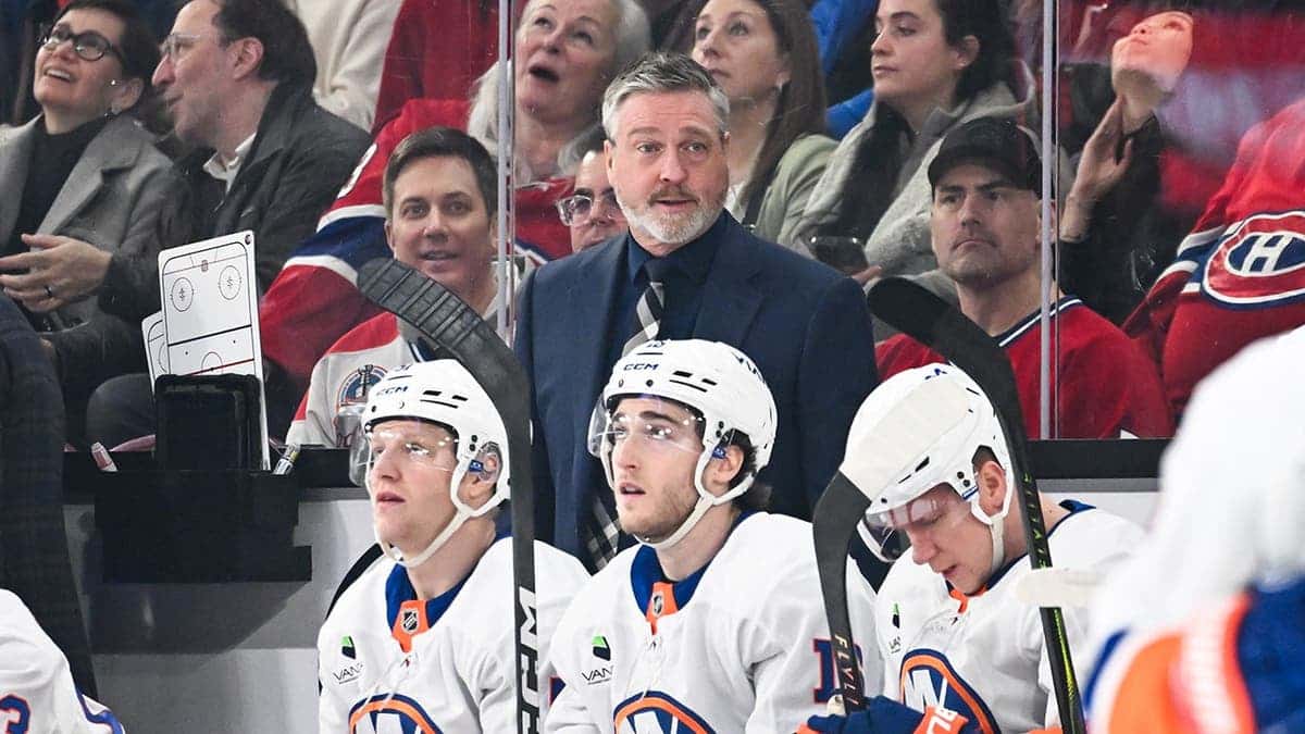 Head coach Patrick Roy standing behind the bench during a hockey game at Bell Centre.