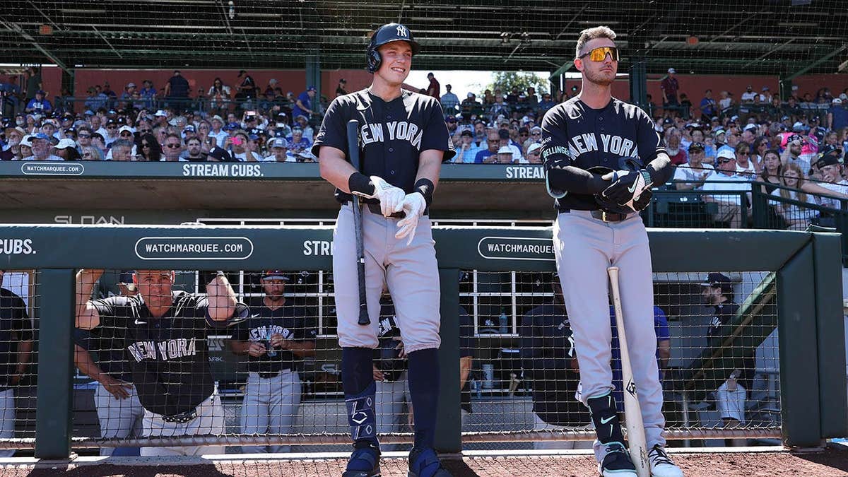 Paul Goldschmidt, Ben Rice and Cody Bellinger of the New York Yankees standing at Sloan Park in Mesa, Arizona