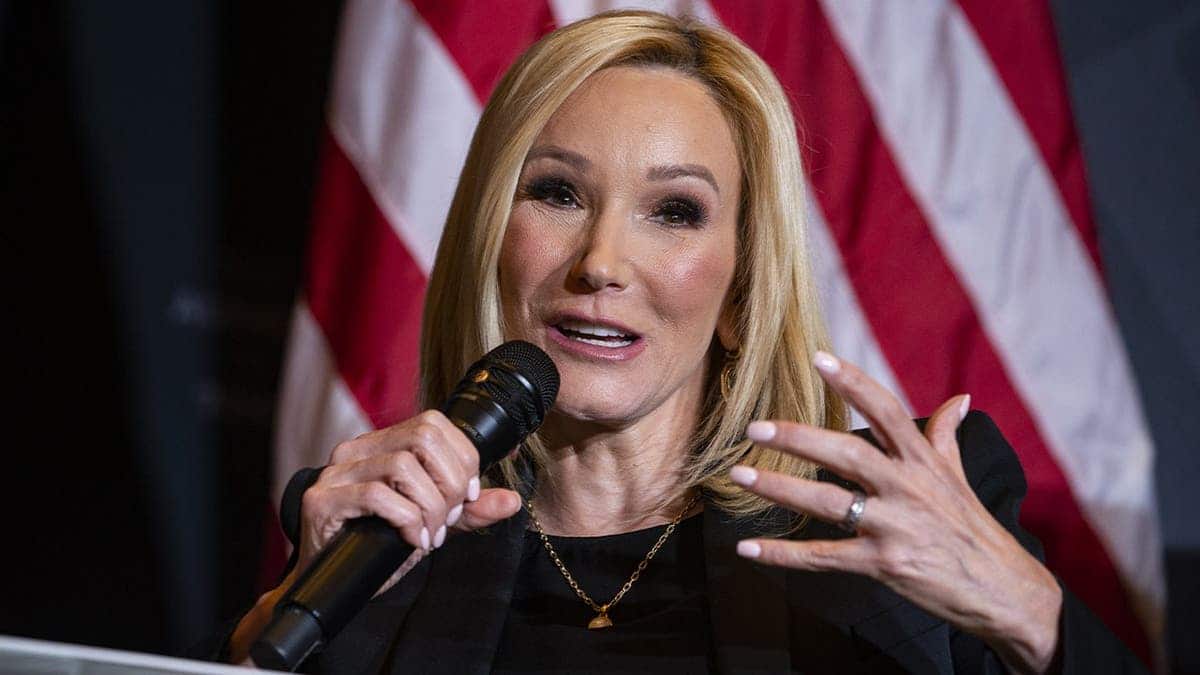 Paula White-Cain holding a microphone