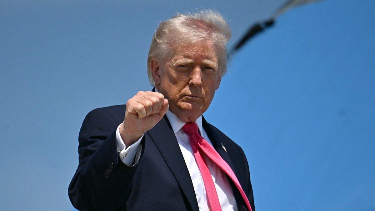 President Donald Trump raising his fist while boarding Air Force One at Joint Base Andrews