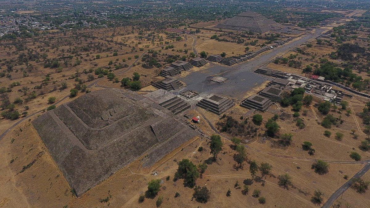 The Pyramid of the Moon and the Pyramid of the Sun with smaller structures along the Avenue of the Dead in Teotihuacan