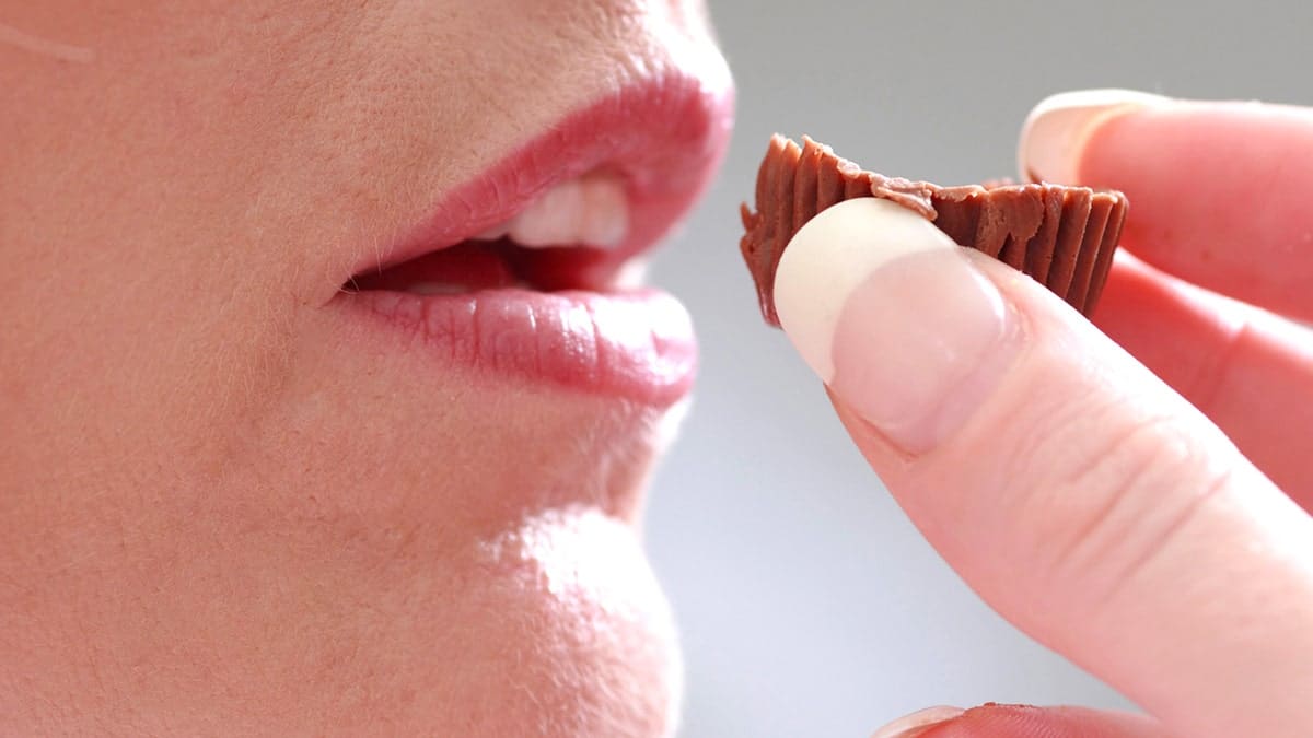 Woman eating a Reese's peanut butter cup