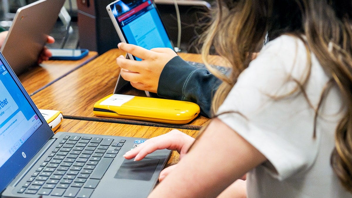 Students studying on computers in a classroom setting