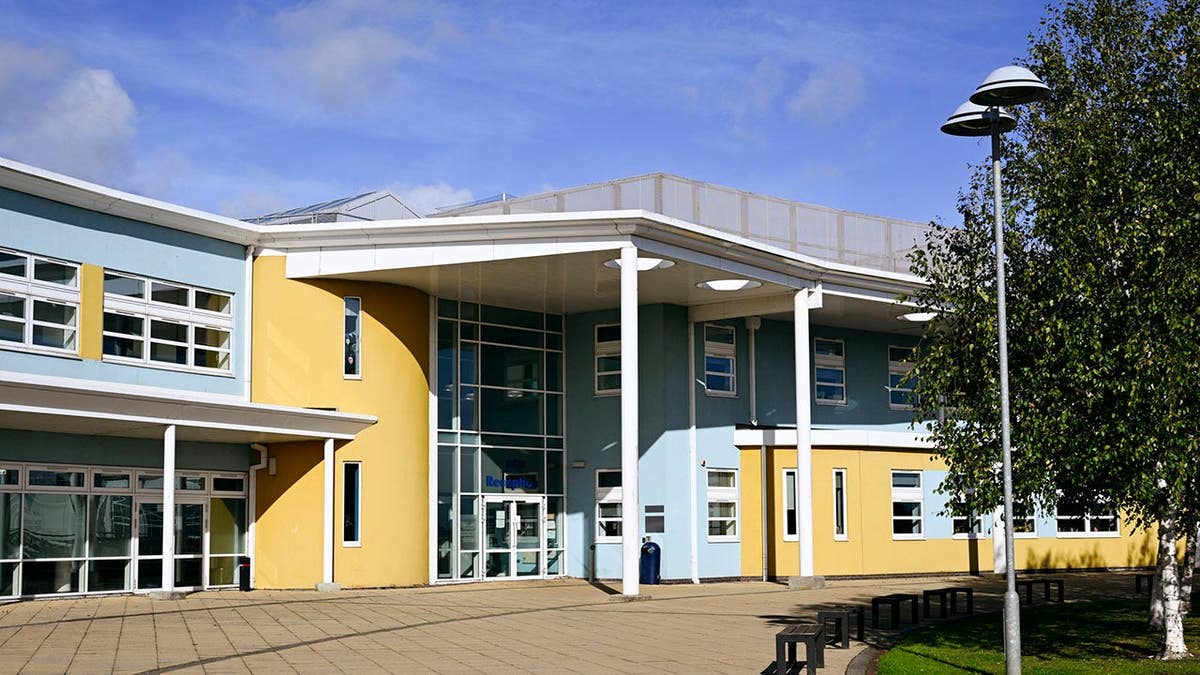 Secondary comprehensive school with empty benches and footpath