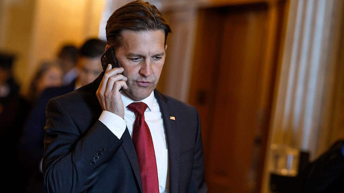 Sen. Ben Sasse speaking on his cell phone while walking through the U.S. Capitol Building.