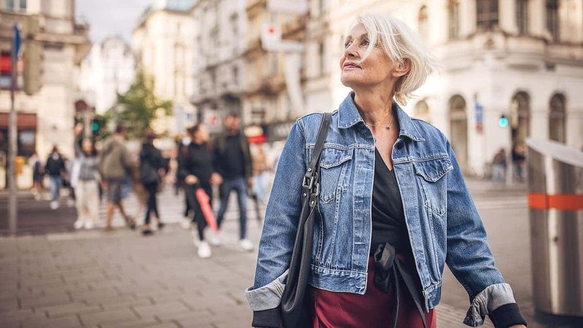 Modern senior woman standing on street in Vienna