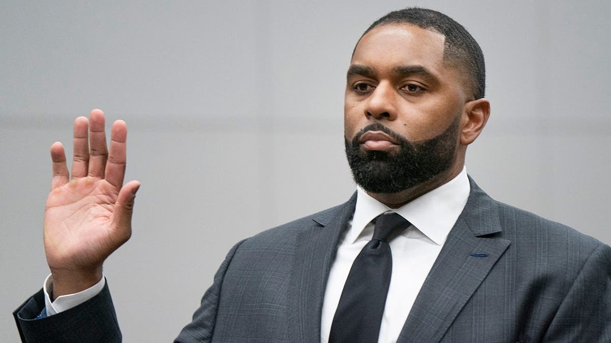 Former University of Michigan head football coach Sherrone Moore being sworn in at a court in Ann Arbor