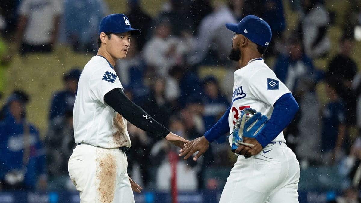 Los Angeles Dodgers' Shohei Ohtani and Teoscar Hernández celebrating on the field