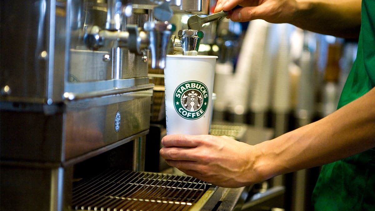 Barista frothing milk for Starbucks latte
