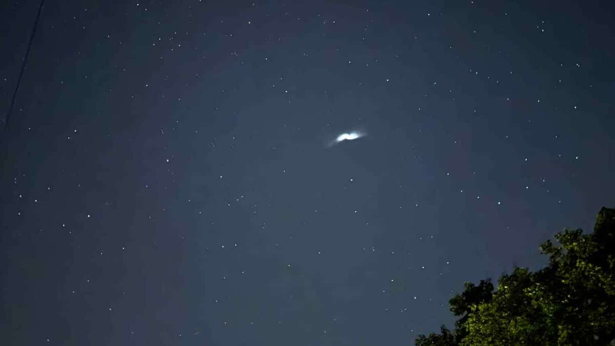 Tanicia Miller capturing a pill-shaped object in the night sky