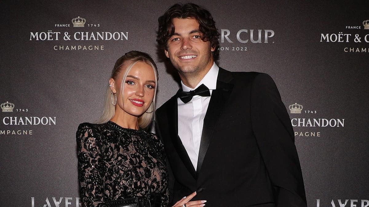 Taylor Fritz and Morgan Riddle posing at a gala dinner in London