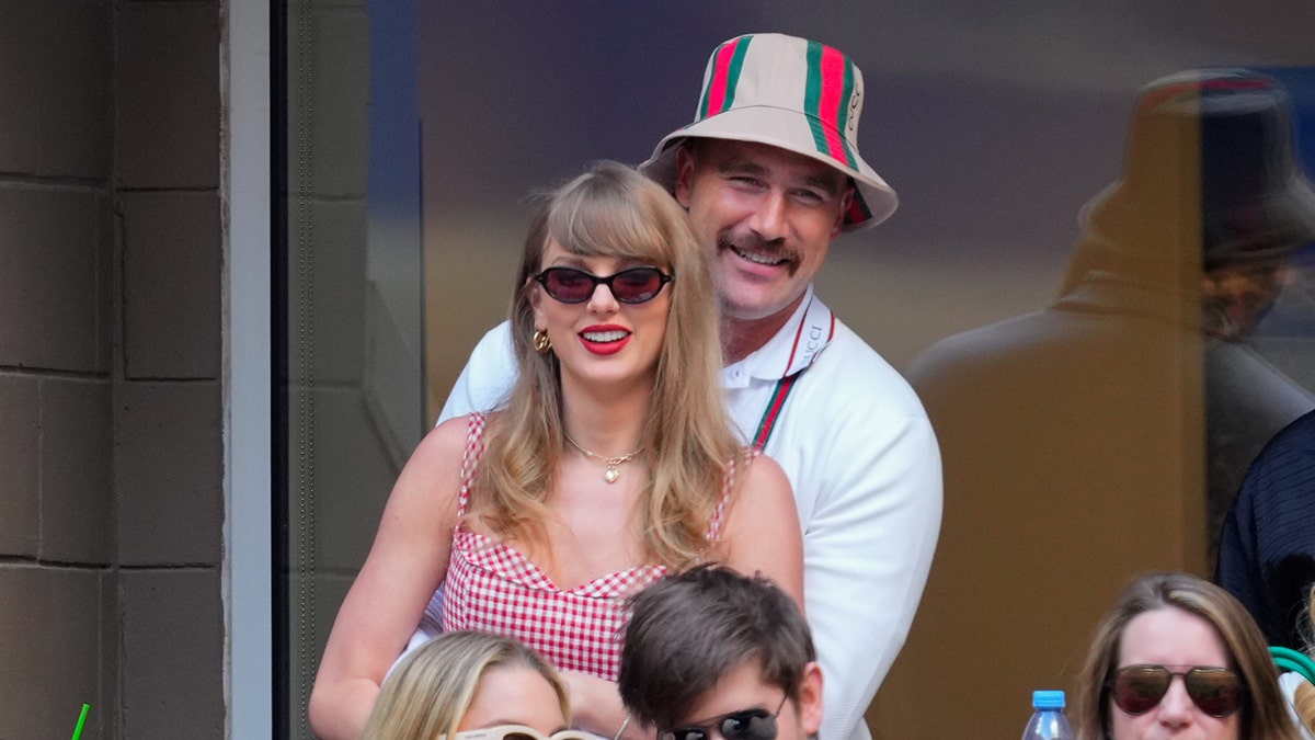 Taylor Swift and Travis Kelce standing together at the 2024 U.S. Open Tennis Championships in New York City