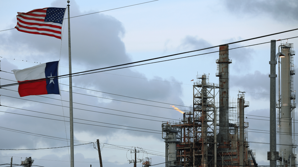 An American and Texas flag fly in front of the Chevron refinery in Texas.
