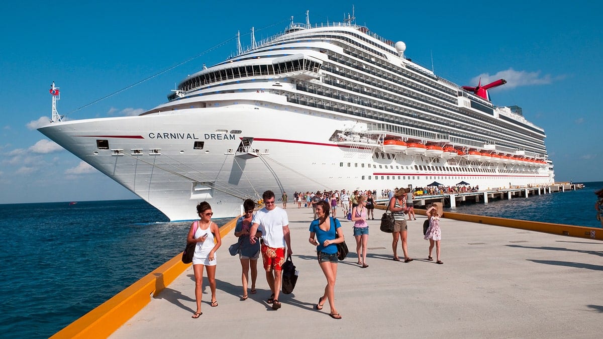 Passengers disembark from the Carnival Dream cruise ship at a sunny port in Cozumel Mexico