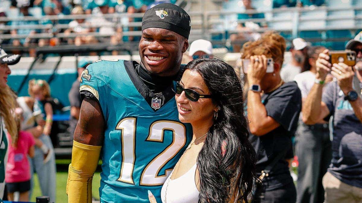 Jacksonville Jaguars player Travis Hunter standing with his wife at EverBank Stadium