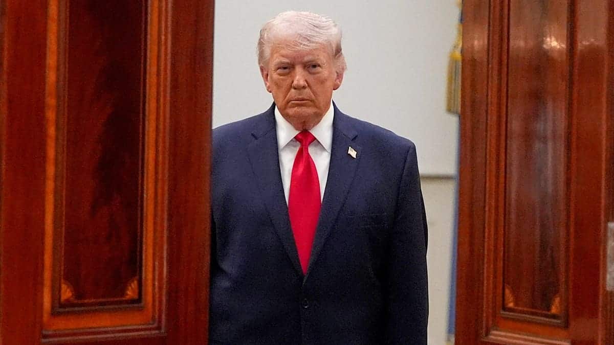 President Donald Trump walking through a door way.