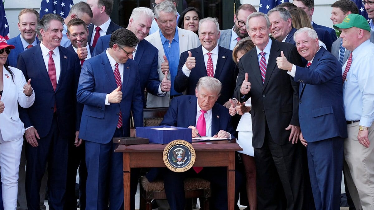 President Donald Trump signing legislation at the White House during Independence Day event