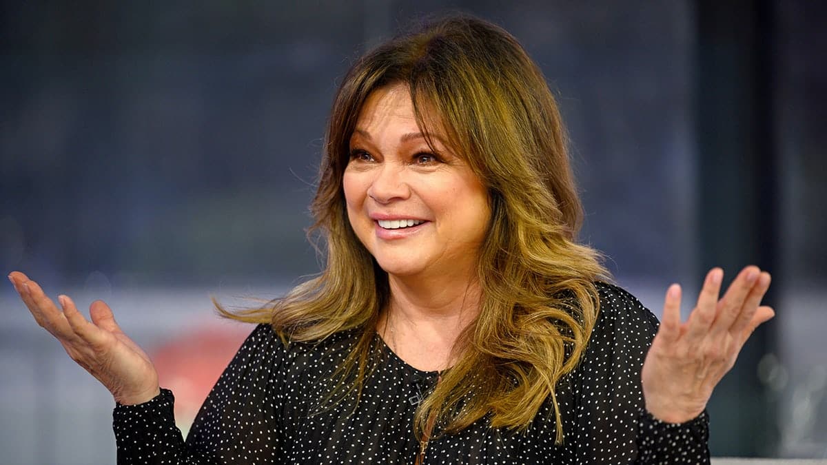Valerie Bertinelli smiling and seated in a studio setting.