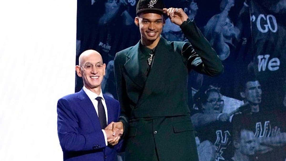 French basketball player Victor Wembanyama shaking hands with NBA commissioner Adam Silver at Barclays Center