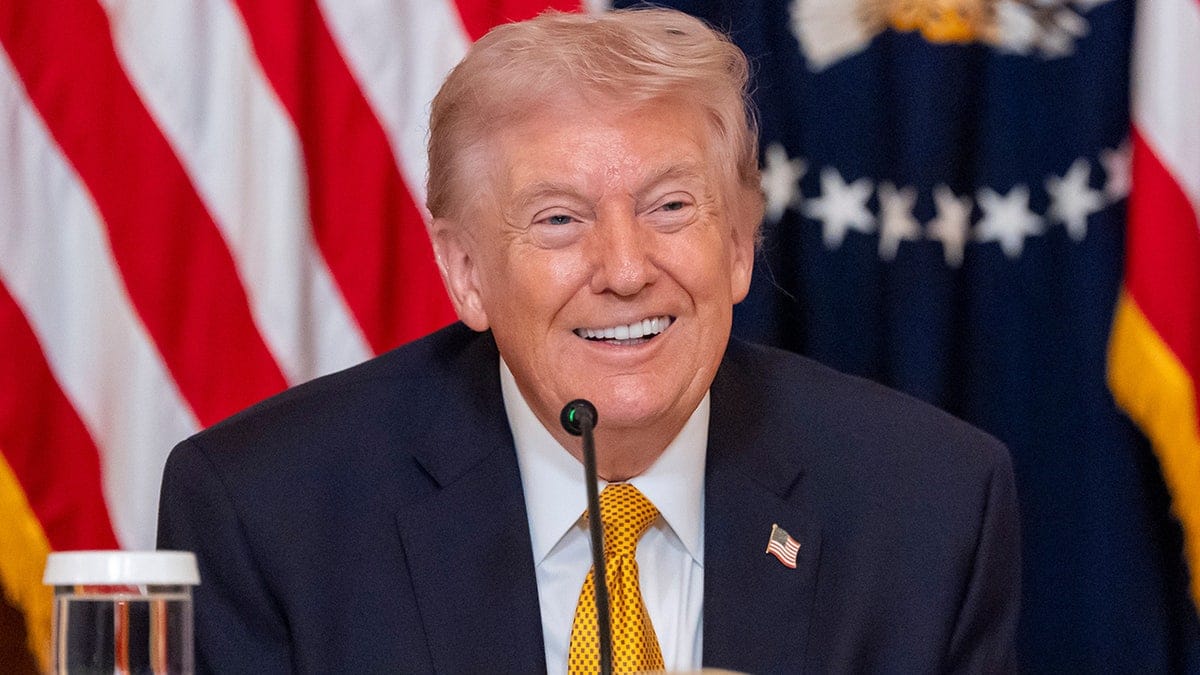 Trump smiles as he speaks