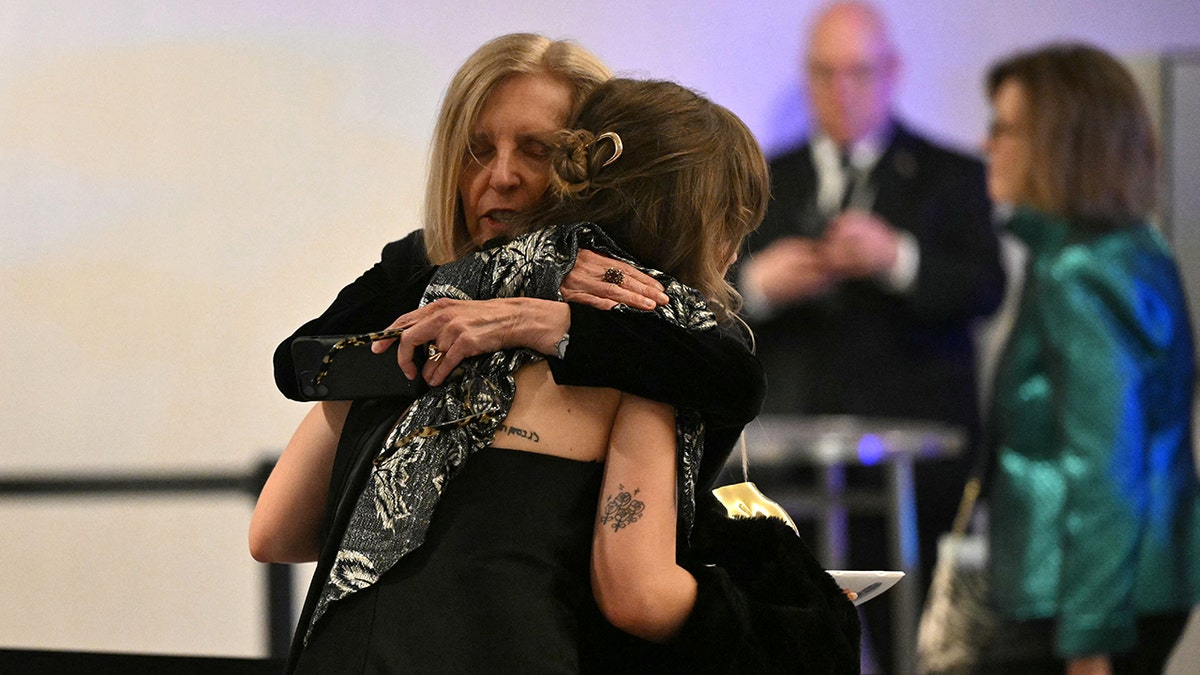 Attendees embracing as they leave the White House Correspondents' dinner at the Washington Hilton in Washington, D.C.