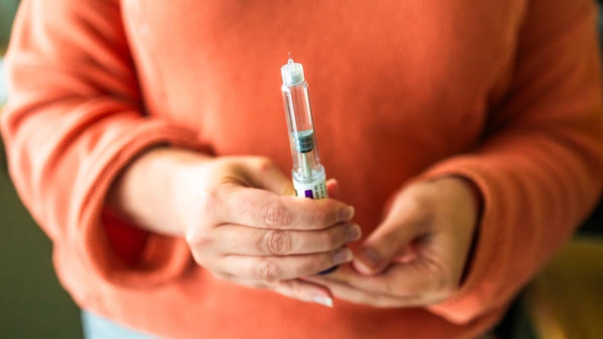 Woman holding GLP-1 medications