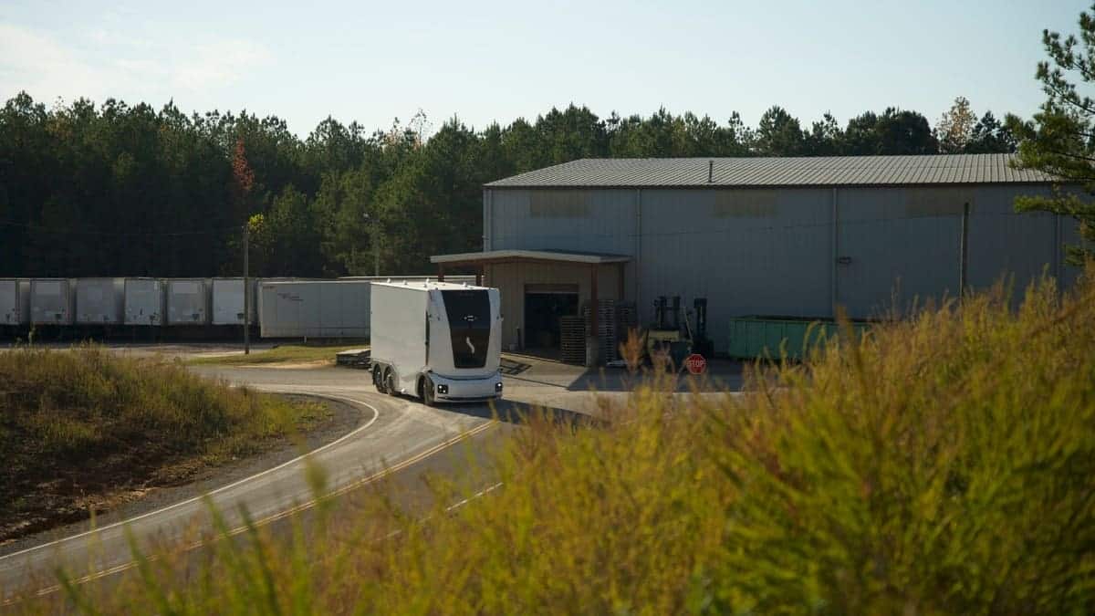 Driverless truck driving down a road.