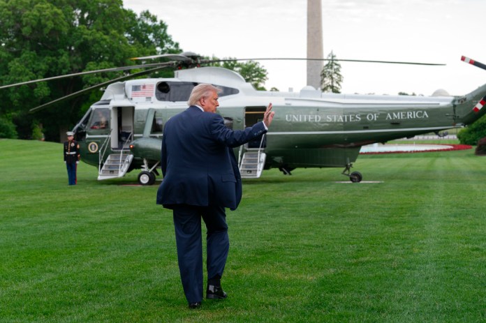 President Donald Trump waves to reporters as he walks to board Marine One on the South Lawn of the White House, Friday, May 8, 2026, in Washington.