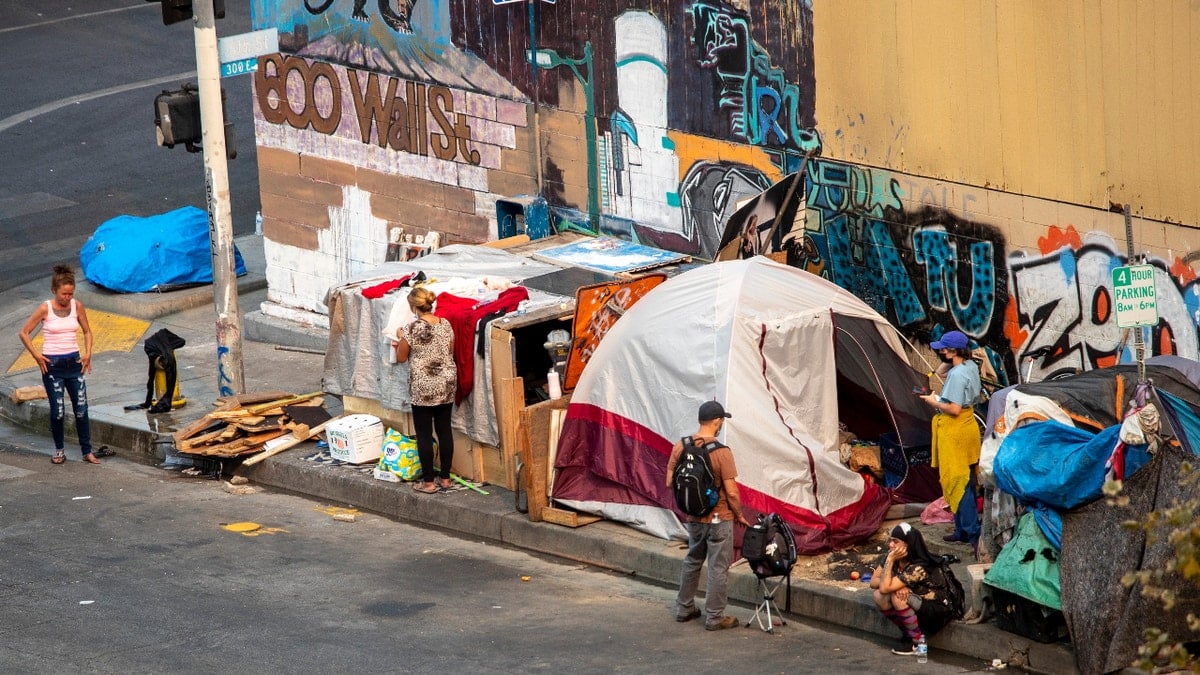 A homeless encampment with tents and belongings on Skid Row in Los Angeles