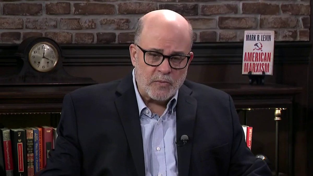 Mark Levin speaking in front of a microphone