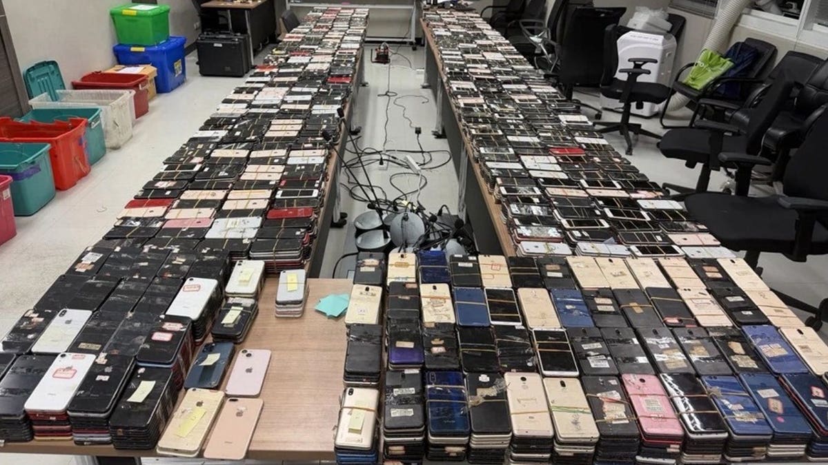 A large number of seized devices from an FBI anti-scam operation in Thailand.