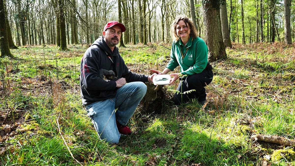John smiling while holding axe in Forest of Dean