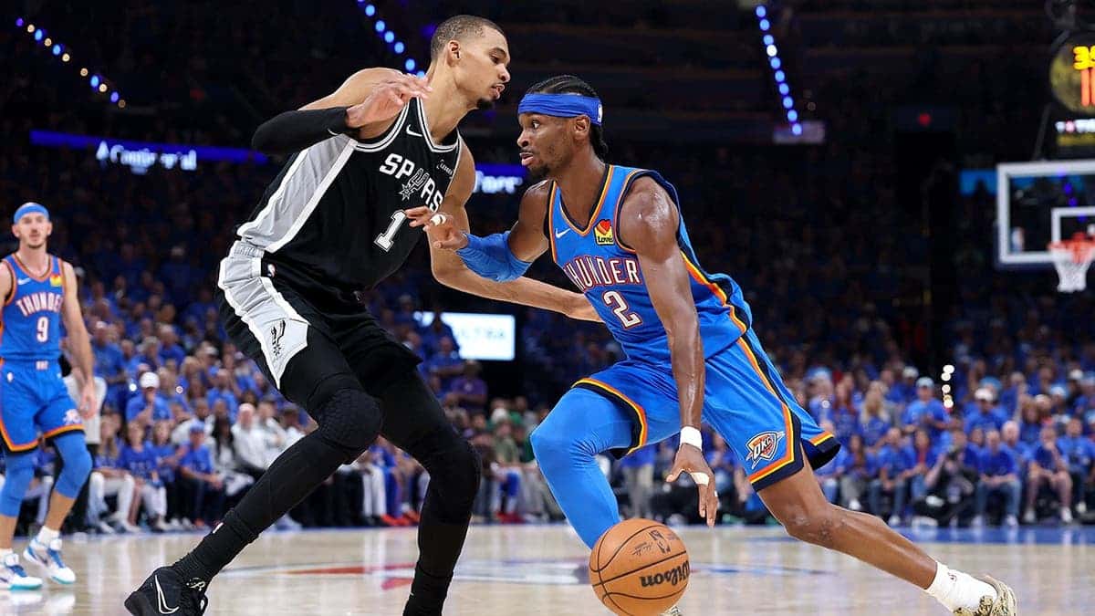 Shai Gilgeous-Alexander driving to basket against Victor Wembanyama during NBA Western Conference Finals