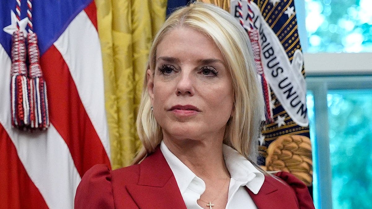 Pam Bondi standing in the Oval Office during an executive order signing.