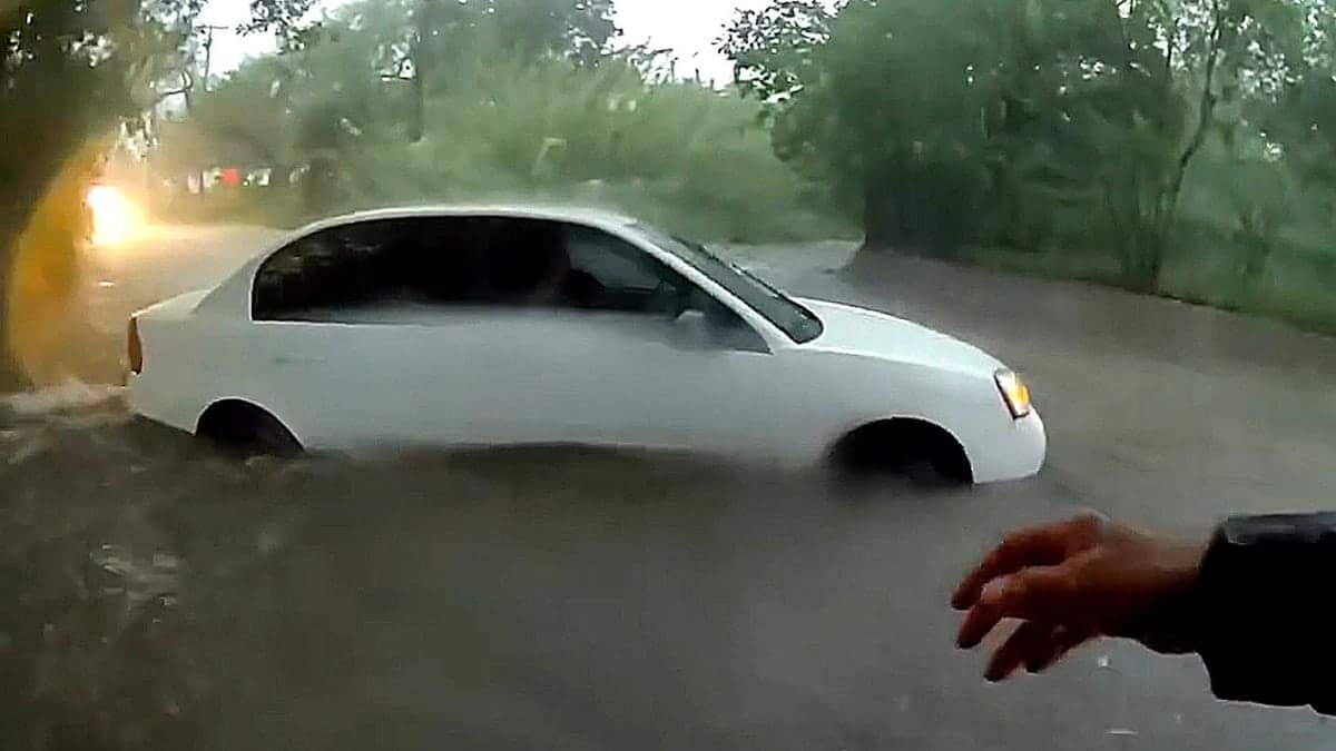 White sedan stuck in floodwaters