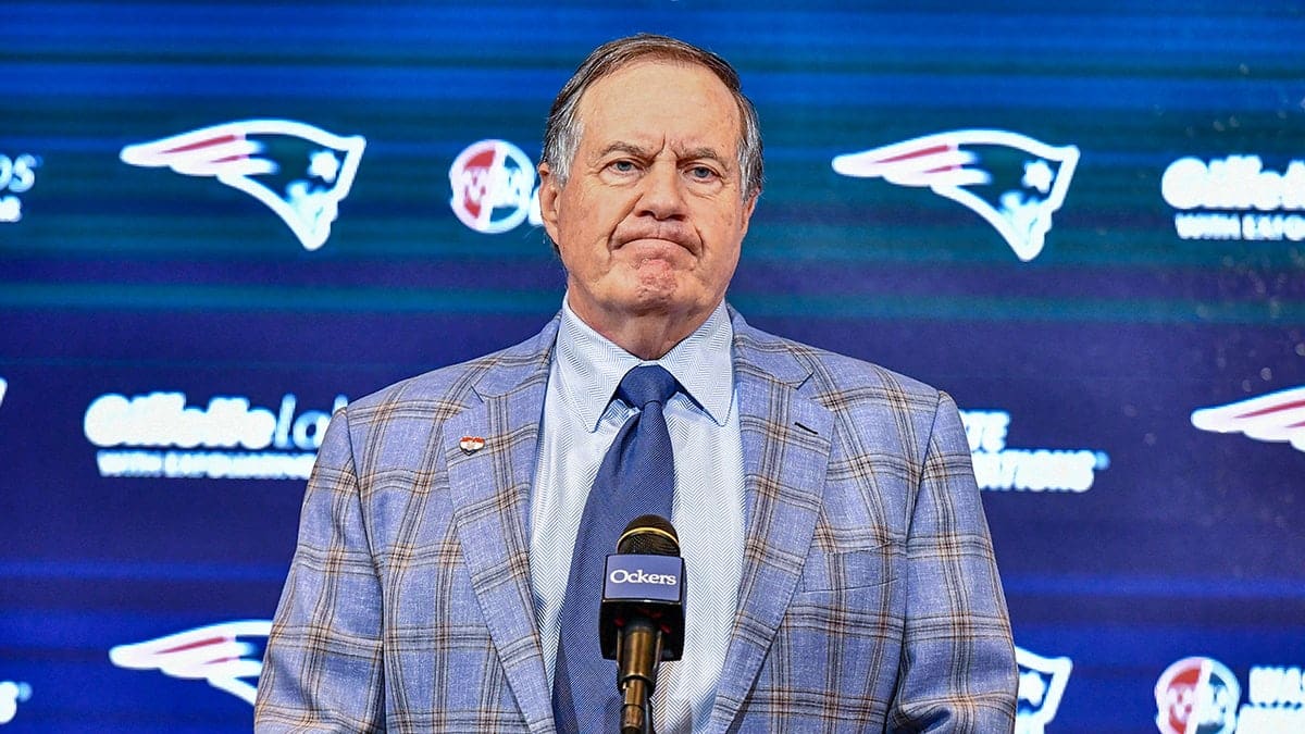 Bill Belichick speaking at a podium during a press conference at Gillette Stadium