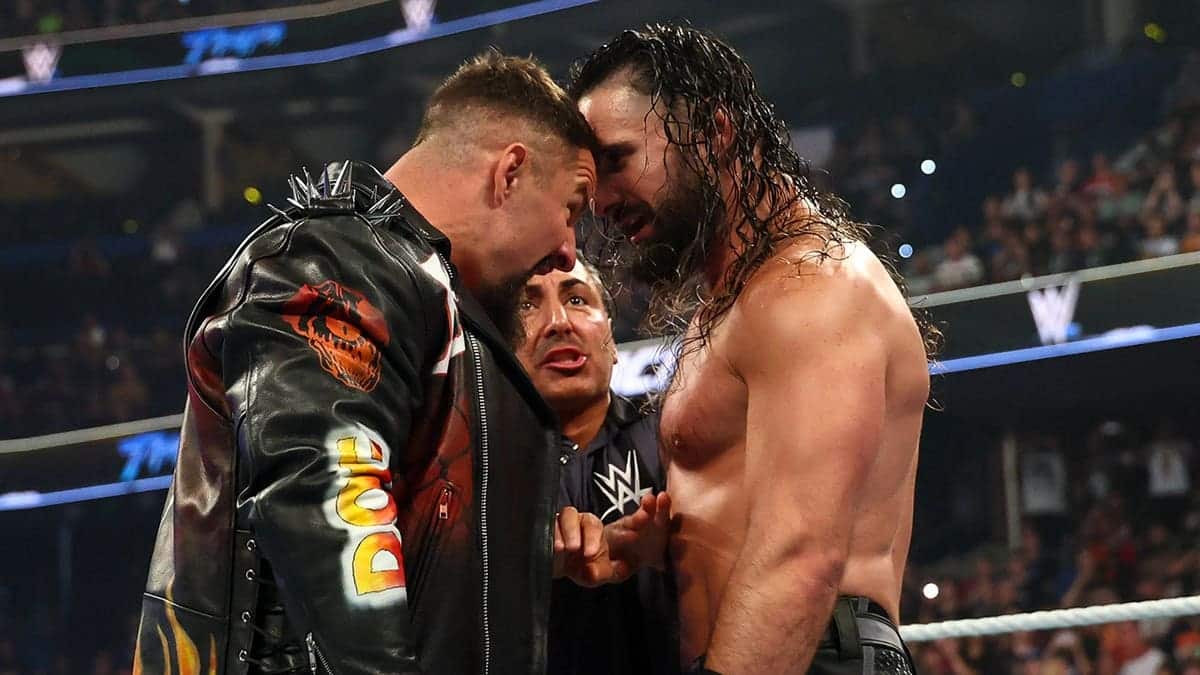 Bron Breakker and Seth Rollins facing off in a wrestling ring