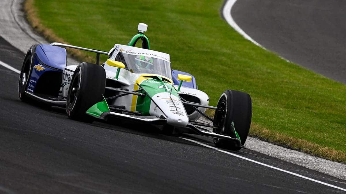 Caio Collet driving a Chevrolet race car on a track at Indianapolis Motor Speedway