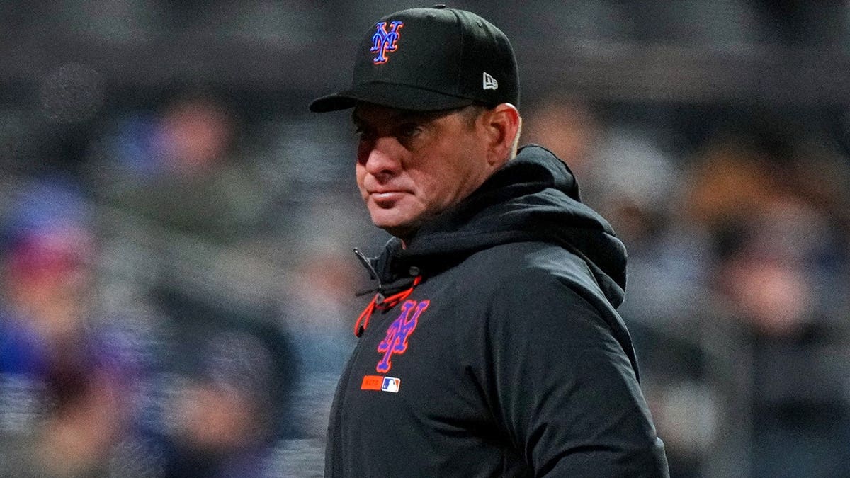 New York Mets manager Carlos Mendoza walking off the field