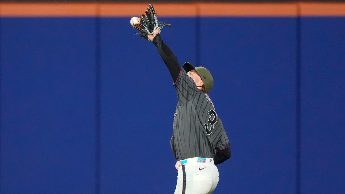New York Mets right fielder Carson Benge reaching for a fly ball during a baseball game
