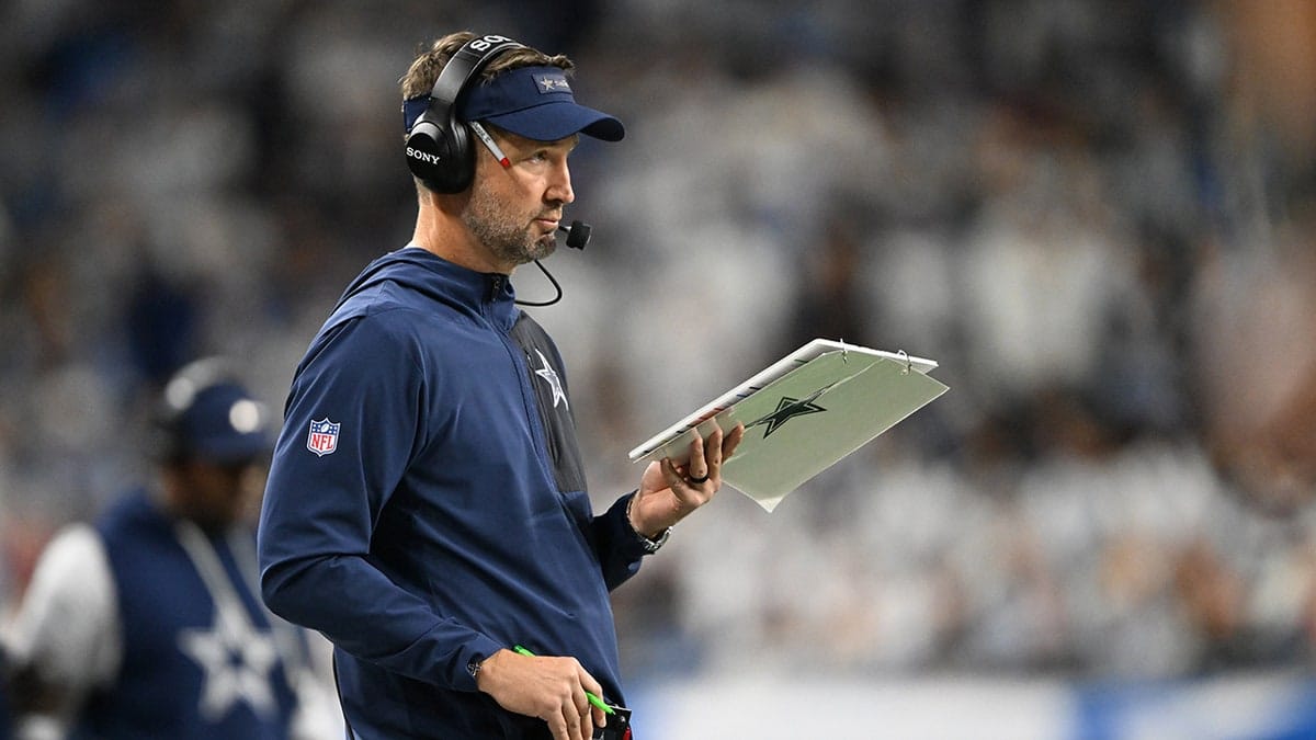 Dallas Cowboys head coach Brian Schottenheimer standing on the sidelines at Ford Field