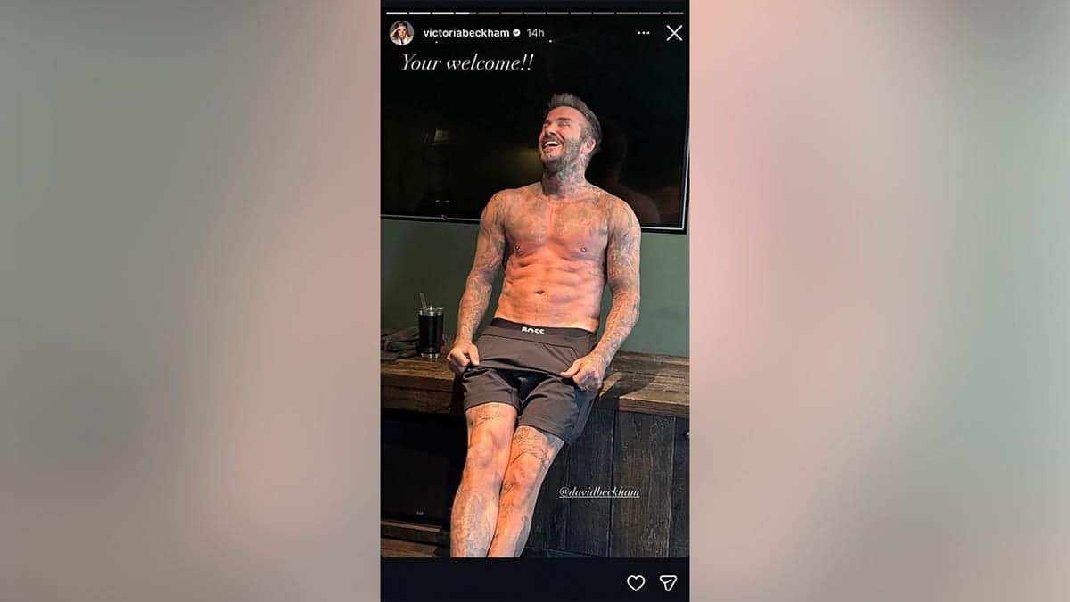 A picture of David Beckham smiling while shirtless in the gym.