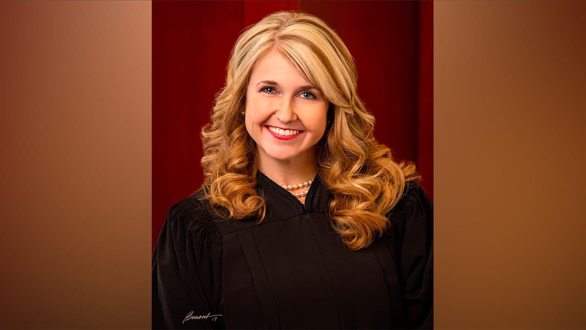 Justice Diana Hagen standing in a courtroom