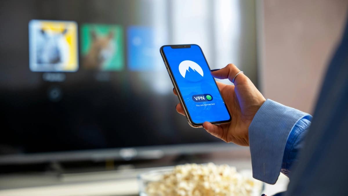A person holding a smartphone displaying a VPN app