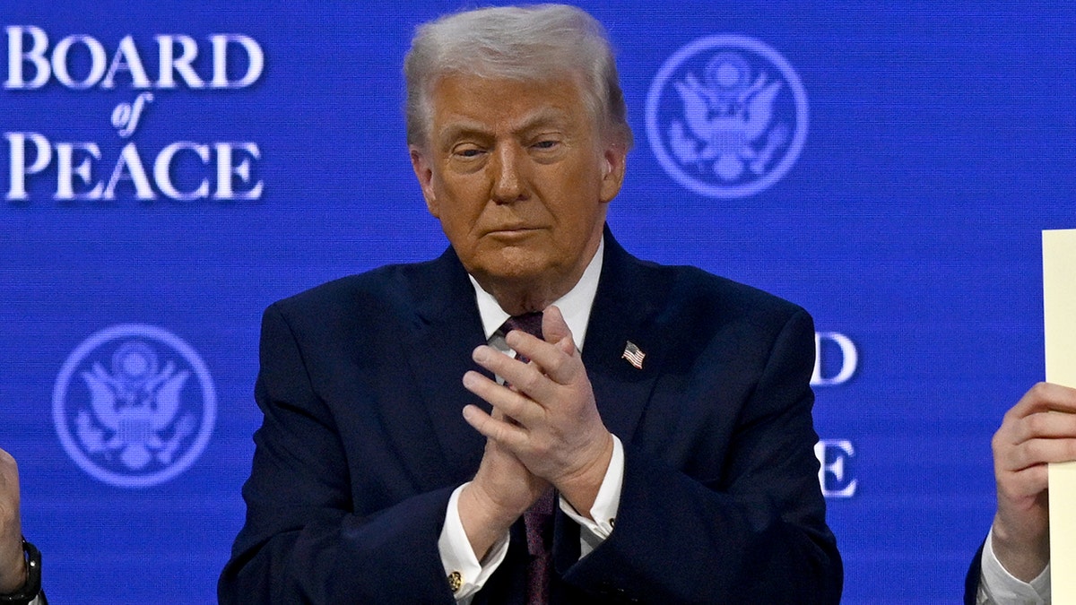 President Donald Trump clapping at the signing ceremony in Davos Switzerland