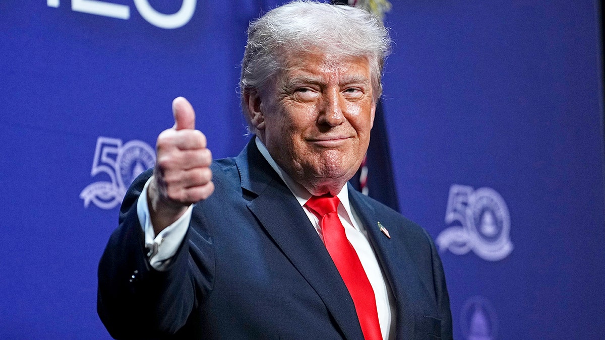 President Donald Trump gives thumbs up before speech