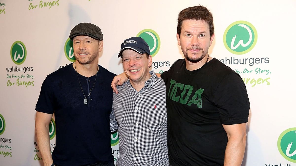Donnie, Paul and Mark Wahlberg pose for a photograph at a Wahlburgers in 2015.