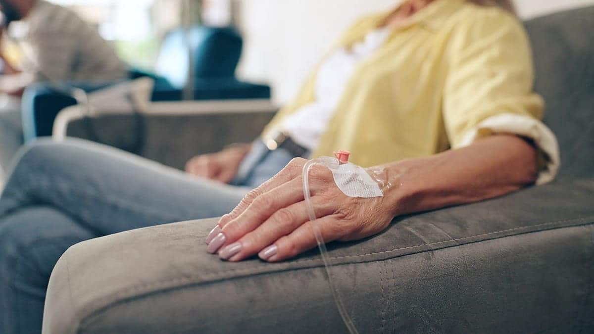 female patient with IV drip in hand