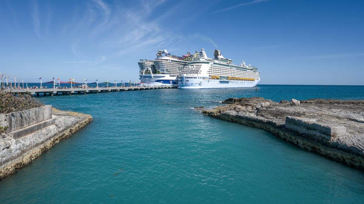 Two Royal Caribbean cruise ships moored at a port in CocoCay Bahamas